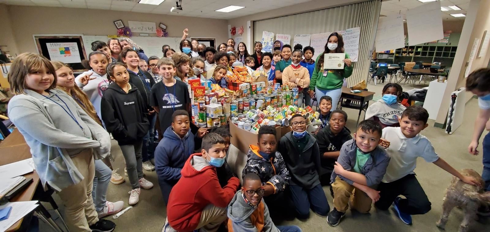 Bess Race Elementary Students and Staff with canned goods.